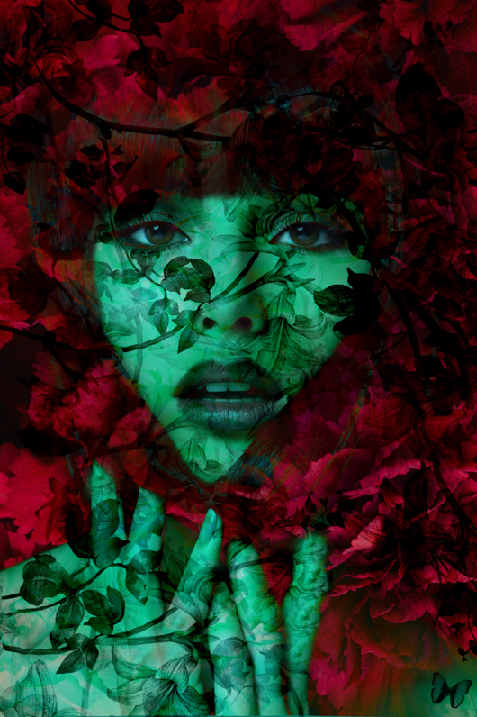 A green woman's face surrounded by red plants