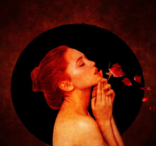 A woman showing her back, featuring a detailed tattoo design and flowers bloosoming from her hands